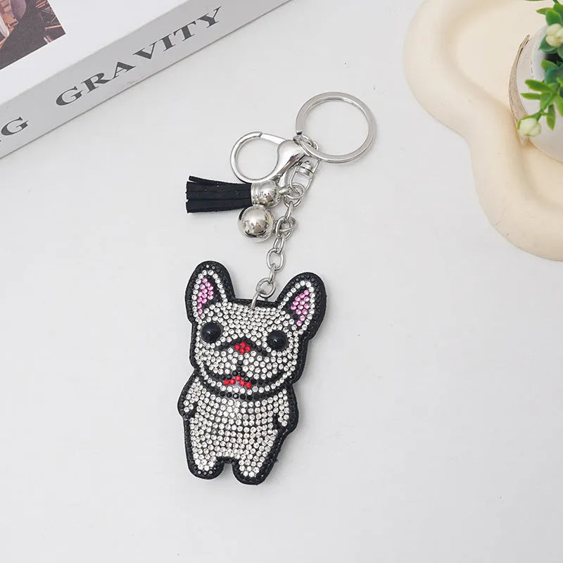 Close-up of a caramel-coloured alloy dog keychain with sparkling clear rhinestones.