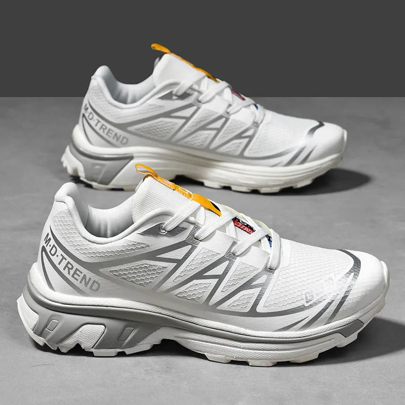 Pair of low-top hiking shoes in artificial leather with a mesh lining and rubber sole.