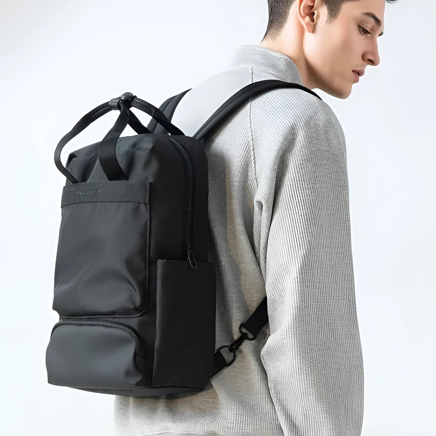 Black Oxford cloth computer backpack showing storage compartments and 20-35 litre capacity