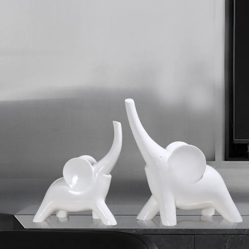Modern minimalist elephant figurine ornament in rose gold or white resin on a plain background.
