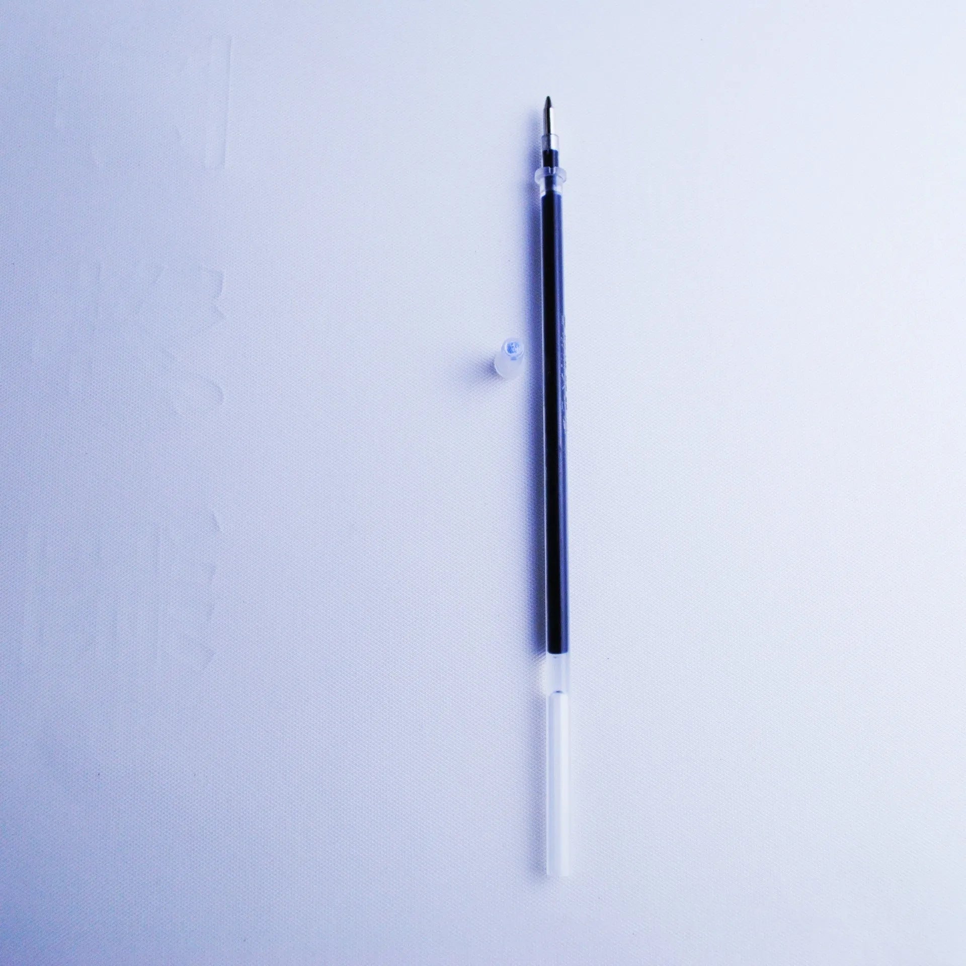 Set of eight blue ink pen refills with 0.5mm tips, a spare pole, and a plastic pen holder.