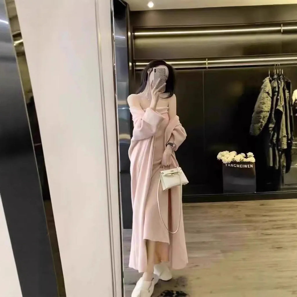 Woman wearing a grey knitted cardigan over a matching long dress with a flocked texture detail.