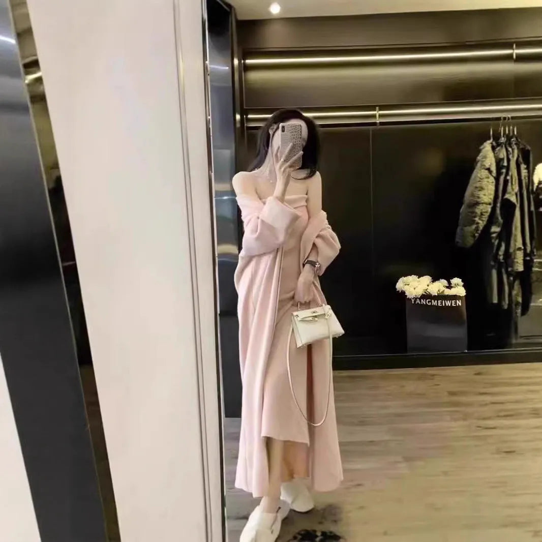 Woman wearing a grey knitted cardigan over a matching long dress with a flocked texture detail.