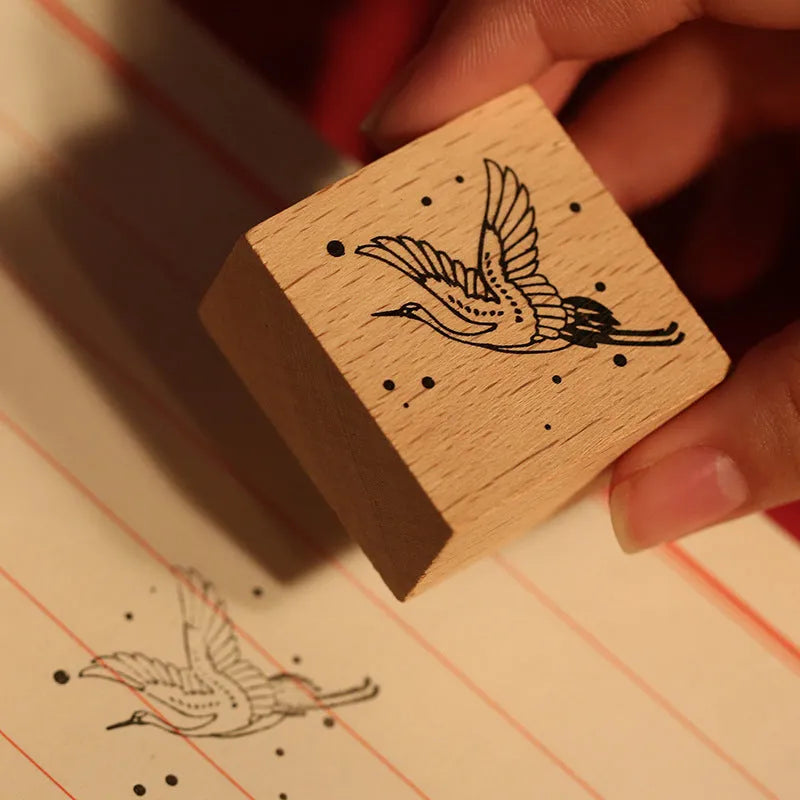 Wooden handled rubber stamp with hand-carved crane design for DIY paper crafting