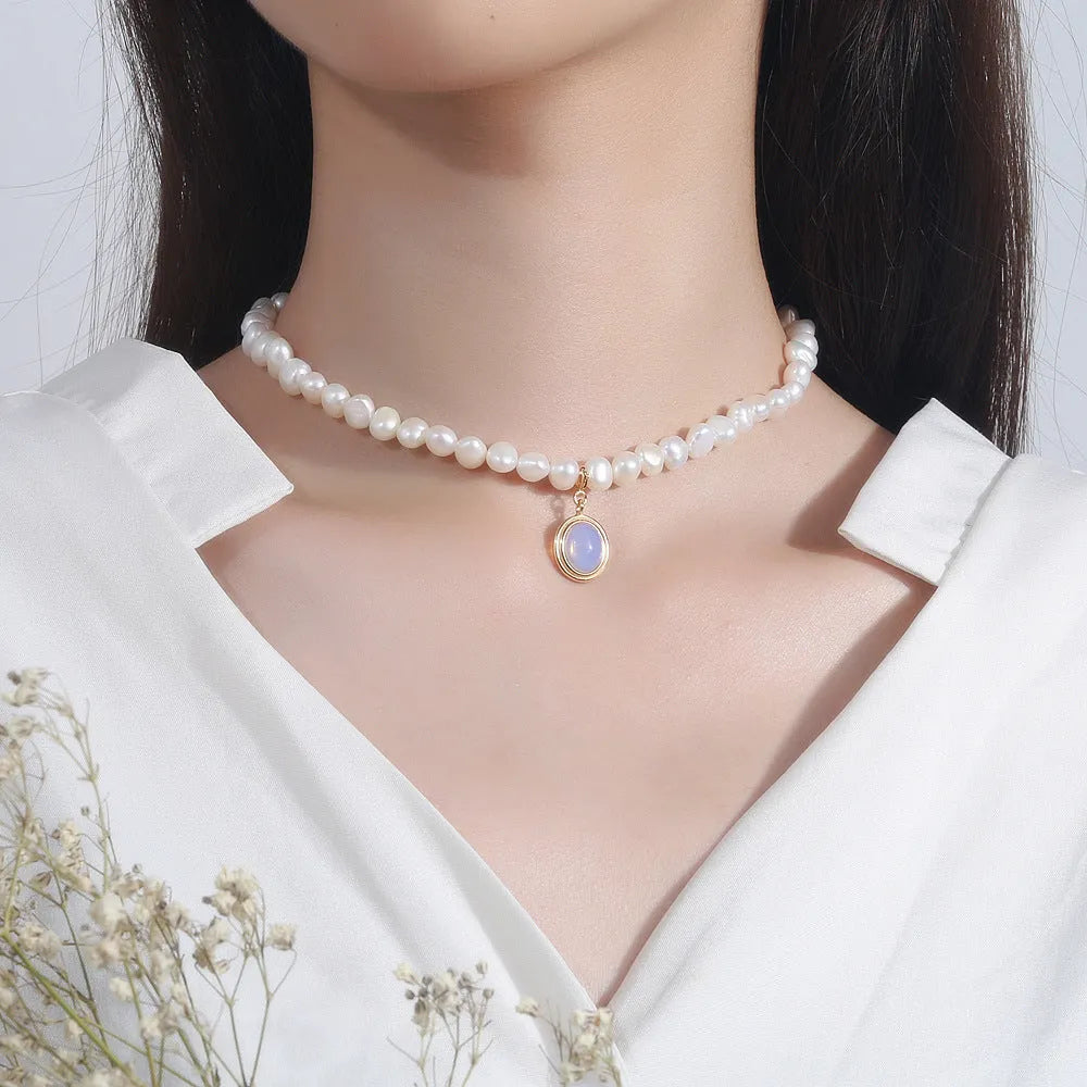 Sterling silver necklace with geometric pearl pendant showing adjustable length chain