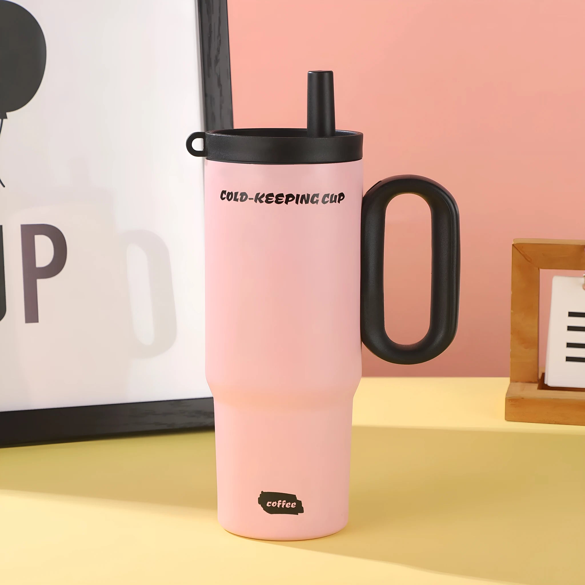 A large insulated portable cup with a handle, shown in multiple colour options.