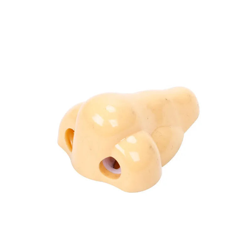 Flesh colour geometry-shaped plastic pencil sharpener for manual use.