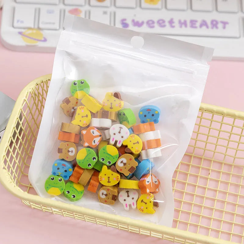 Sealed plastic bag containing 50 small cartoon-themed erasers in shapes like fruits, animals, and Christmas symbols.