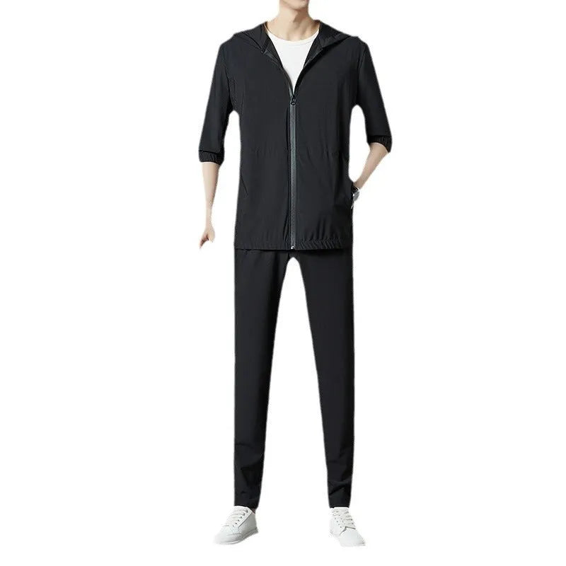 Grey loose-fit hooded sun-protective jacket and trousers set on a hanger