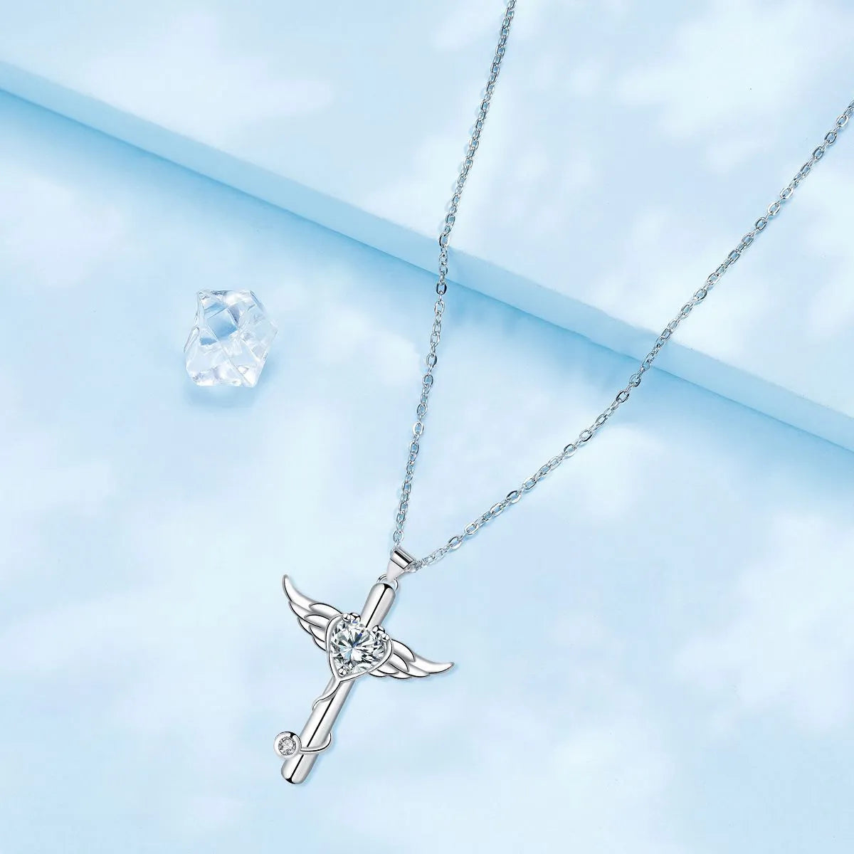 Close-up of a women's necklace with a cross, stethoscope, and wings pendant in electroplated copper.