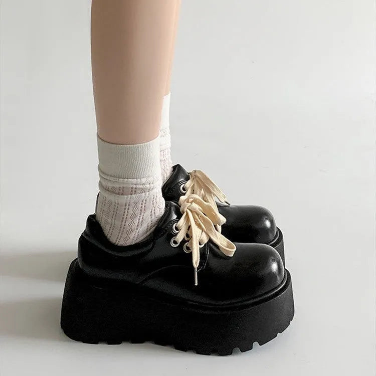 Matte black women's lace-up shoes with a chunky muffin heel and thick rubber sole