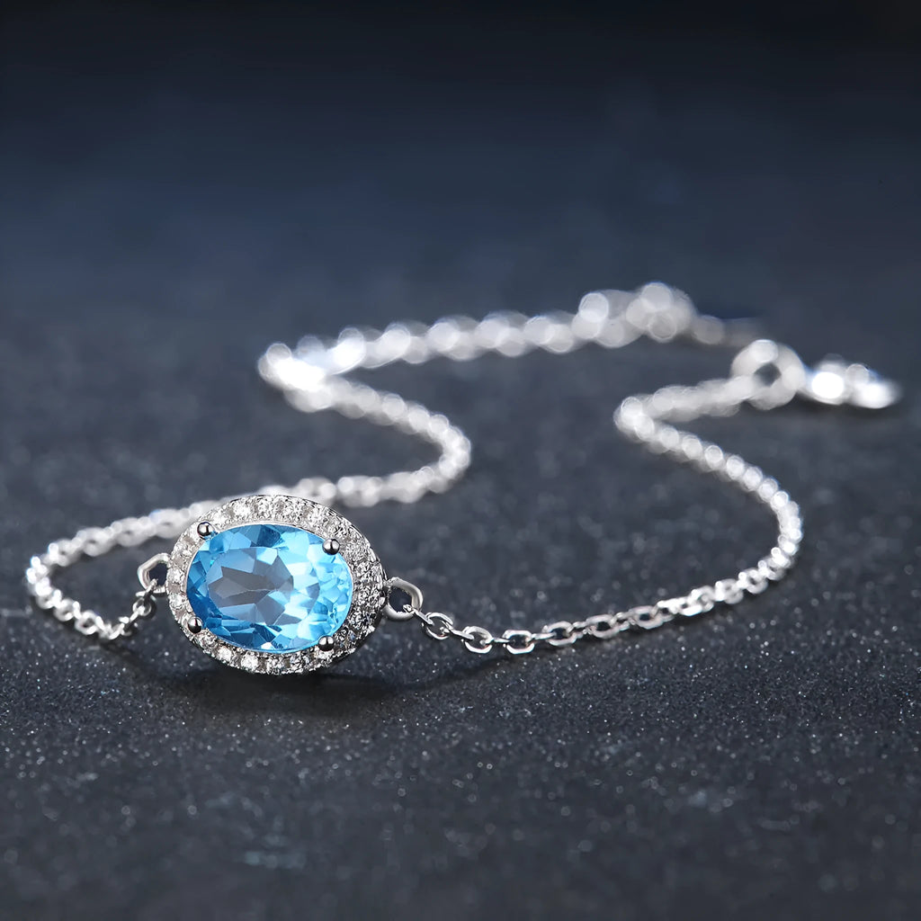 925 sterling silver blue topaz geometric jewellery set showing necklace, earrings, ring, and pendant