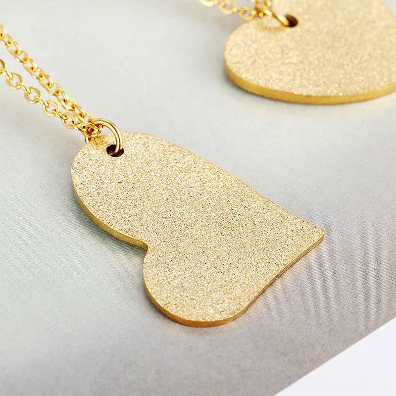 A geometric heart-shaped blue titanium steel pendant necklace on a chain.