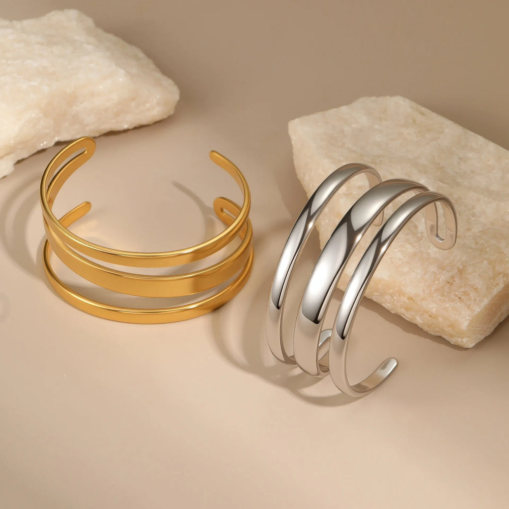 Geometric line design stainless steel bracelet with simple opening clasp, shown in gold and steel colour options.