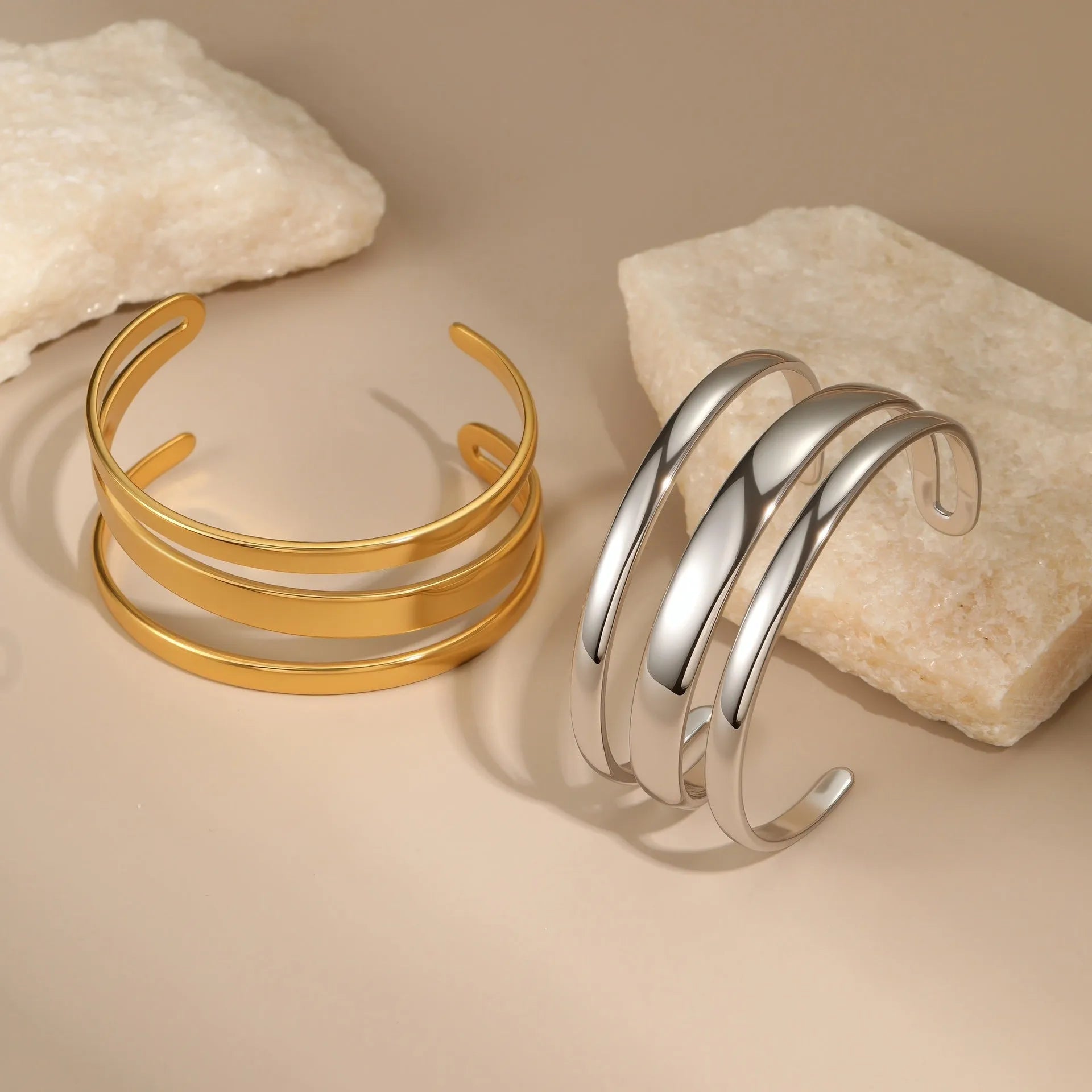 Geometric line design stainless steel bracelet with simple opening clasp, shown in gold and steel colour options.