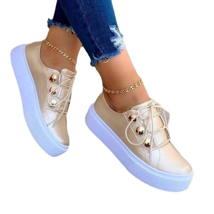 Women's white lace-up casual flats with silver rivet details on a low-top round toe shoe.