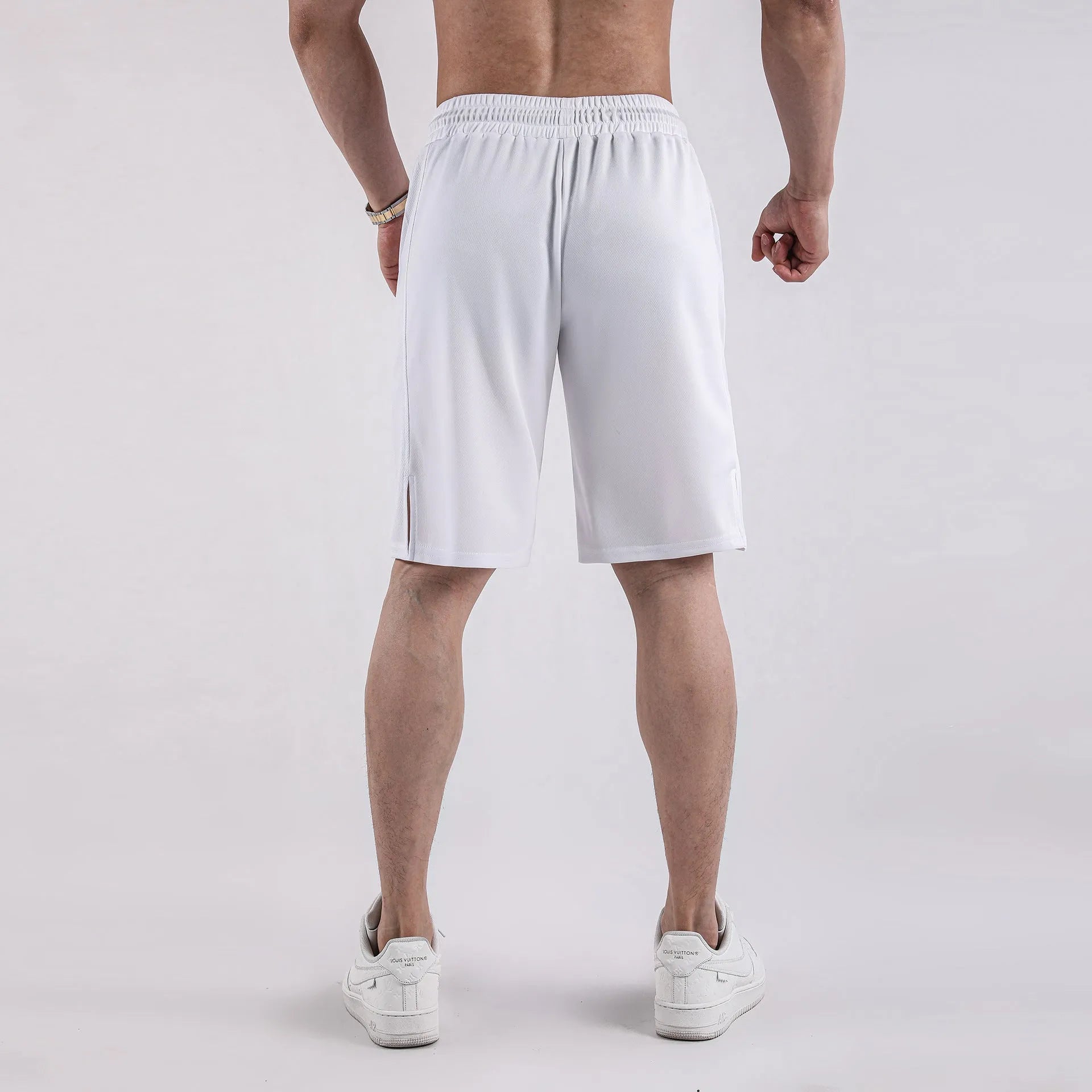 Men's black quick-dry mesh capri shorts with an elastic waistband, shown in a loose, casual fit.
