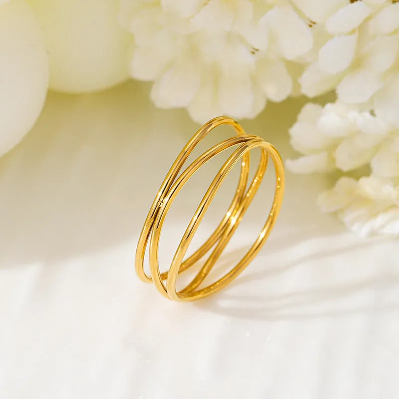 Gold geometric line ring with three-layer coil design on titanium steel band