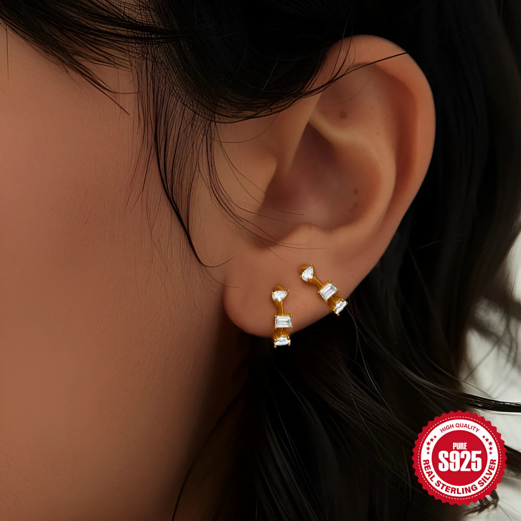 Sterling silver geometric stud earring with a central diamond detail on a white background.