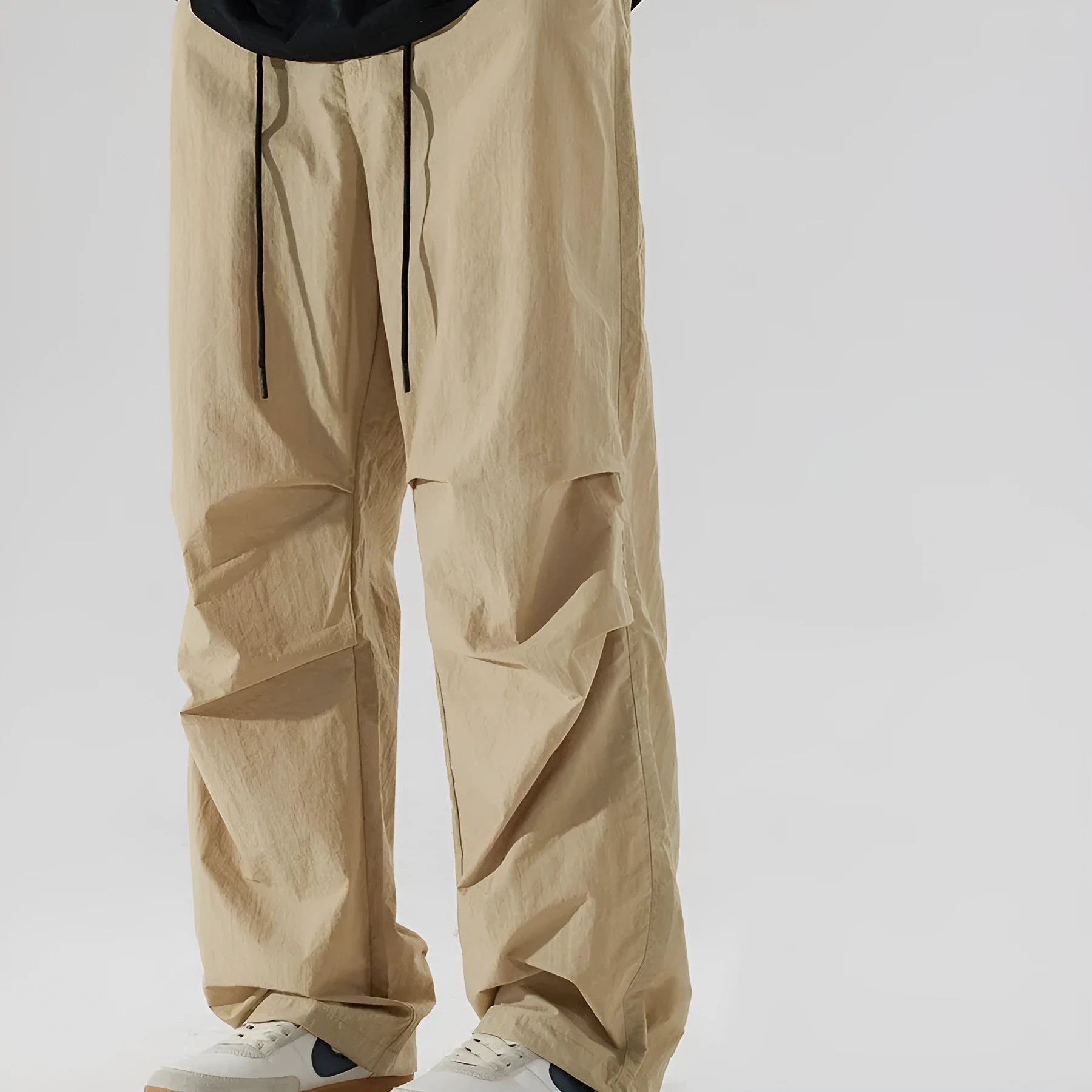 Men's loose straight-leg casual trousers in thin ice silk nylon fabric, shown in apricot colour.