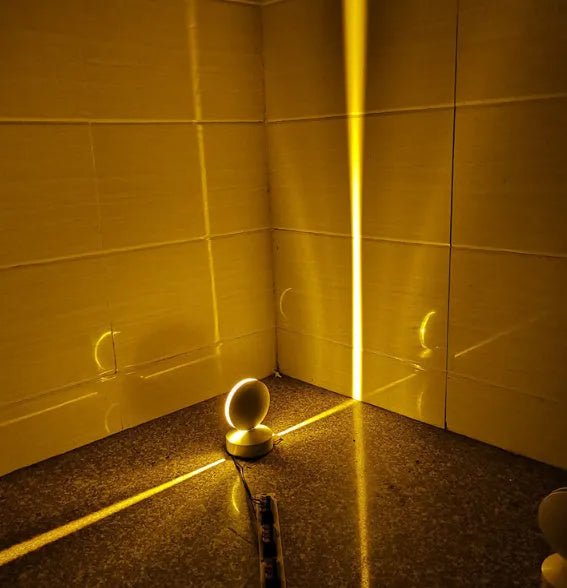 Modern aluminium spotlight bar wall lamp with glass lens, mounted on a wall.