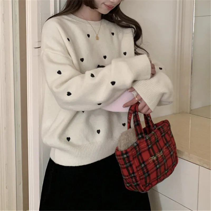 Women's loose fit acrylic pullover sweater in milky white, showing crew neck and long sleeve design.