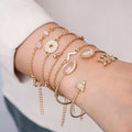 Set of six gold bracelets with arrow, water drop, and V shapes featuring spot drill detail.