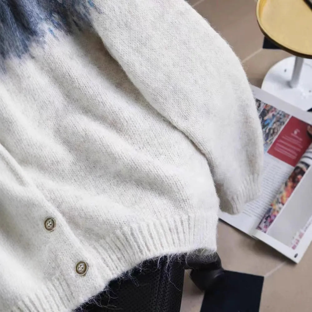 Women's loose fit jacquard knit sweater coat in contrast colours, showing long sleeves and textured pattern.