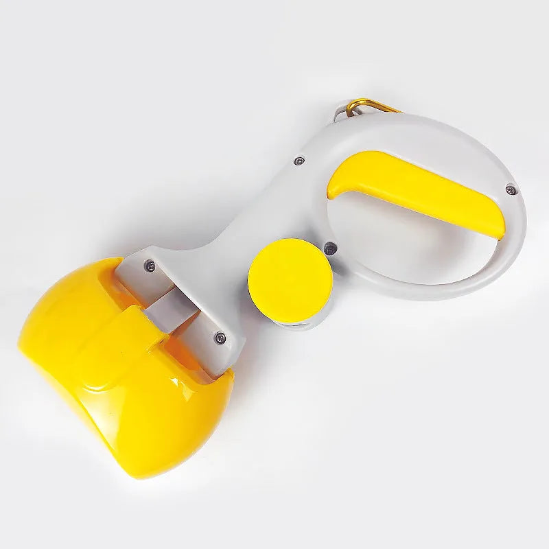 Black pet pooper scooper with built-in trash bag holder made of ABS plastic on a grass lawn.