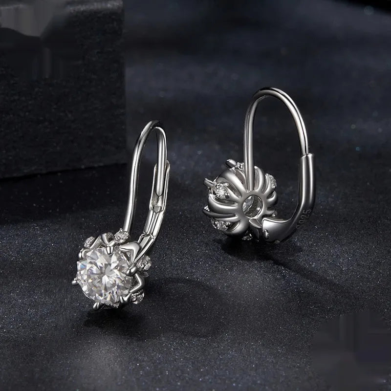 Sterling silver flower bud ear clips with white gold plating and a moissanite centre stone.