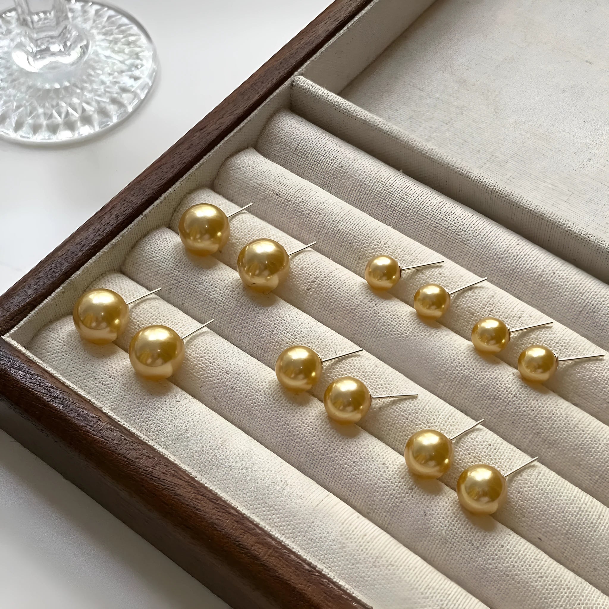 Large pearl stud earrings with a geometric star detail, shown in silver.