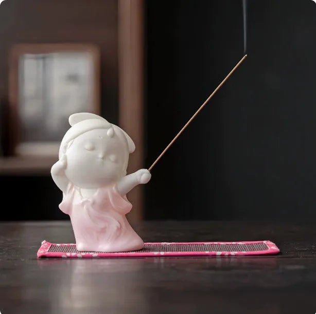 Ceramic cute court attendant incense burner decoration in fresh style on a plain background.