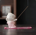 Ceramic cute court attendant incense burner decoration in fresh style on a plain background.