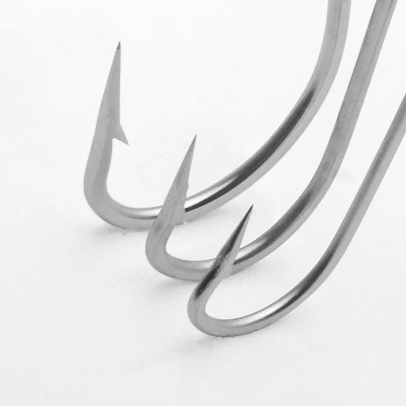Assortment of multi-style alloy sea fishing hooks for weever and snakehead on a blue background.