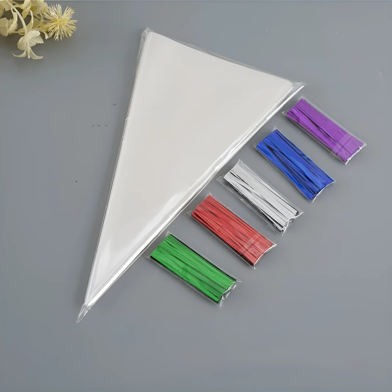 Clear triangle-shaped plastic packaging bag with a silver tie wire, showing three size options.