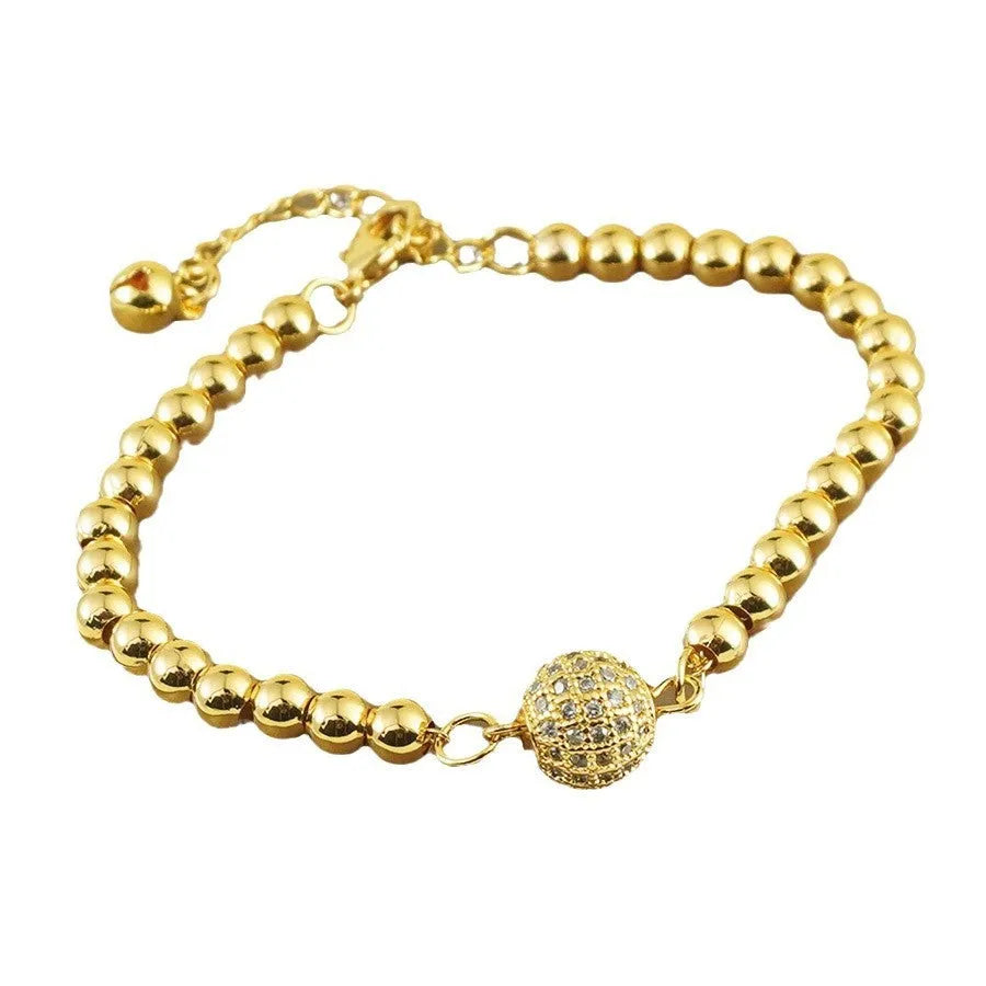 Close-up of a women's copper bracelet with a heart shape design and round zircon stone accents in an Arabic style.