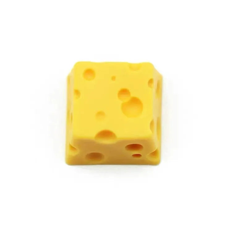 Yellow resin cheese character key cap for mechanical keyboards on a white background.