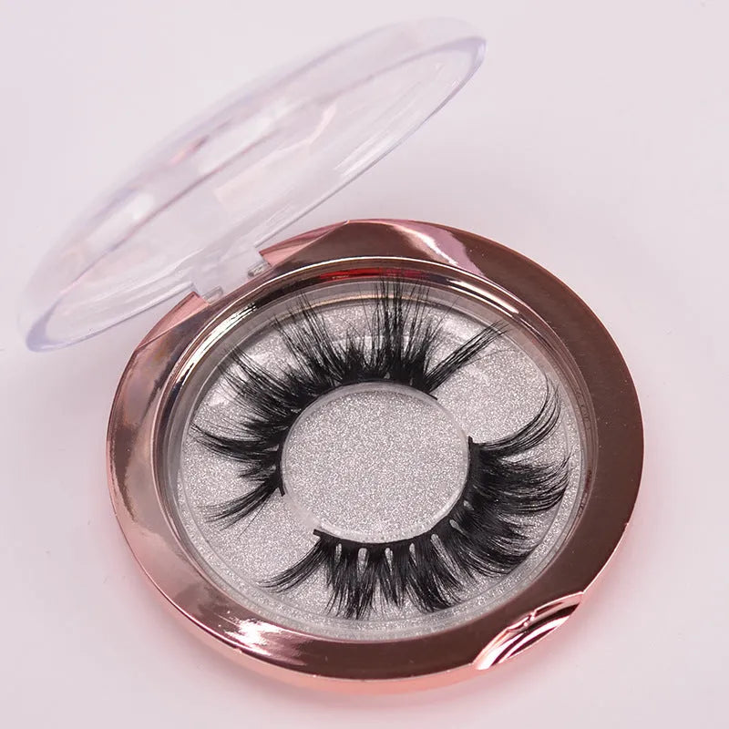 5D mink false eyelashes set with hair cap and double-headed brush on a white background.