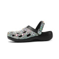 Black platform sandals for women with rhinestone detail and open-hole design on a lightweight EVA sole.