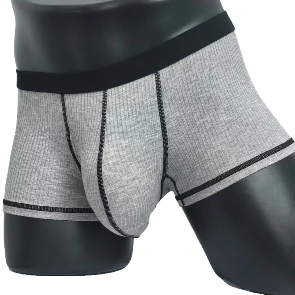 Men's solid colour breathable boxer shorts on a white background showing hip lifting design.