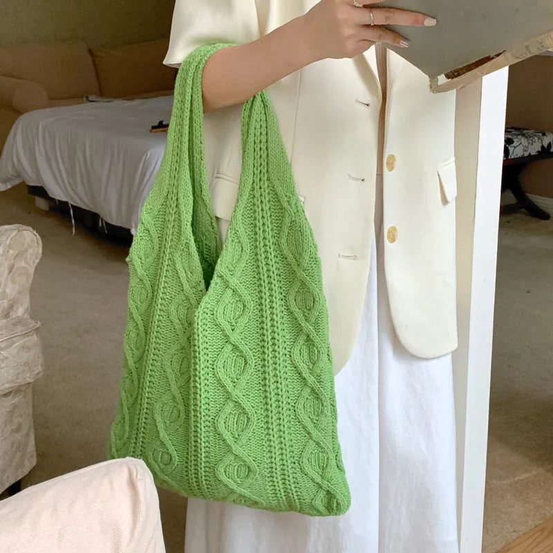 GWomen retro crochet shoulder tote bag in a solid colour, showing knitted texture and double strap connectors.