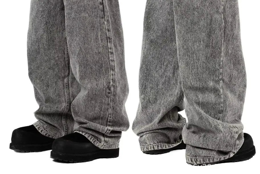 Grey loose-fit straight-leg denim trousers for men laid flat, showing mid-waist and straight-leg cut.