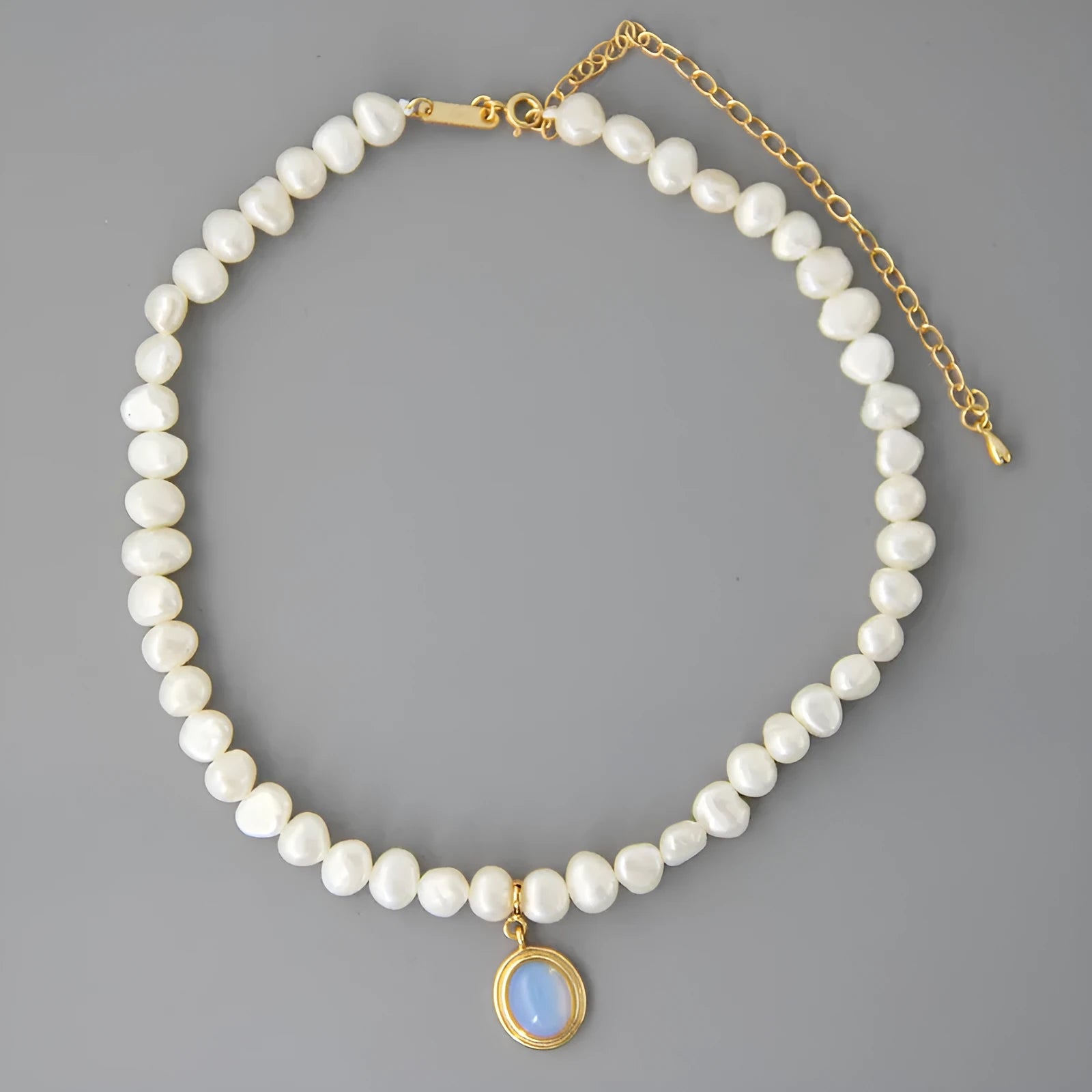 Sterling silver necklace with geometric pearl pendant showing adjustable length chain