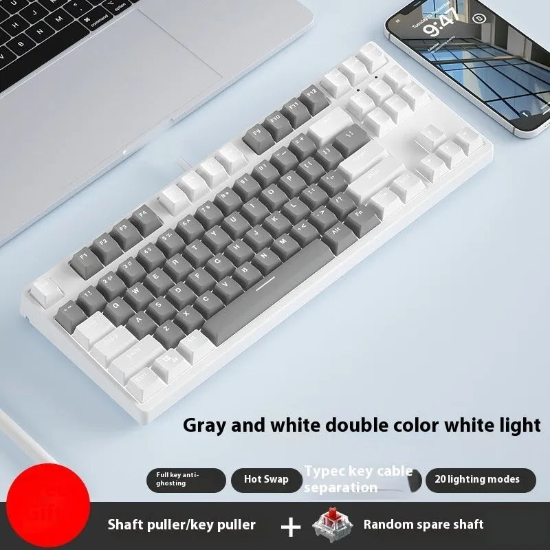87-key wired mechanical keyboard with two-tone keycaps, shown with switch puller and cleaning brush