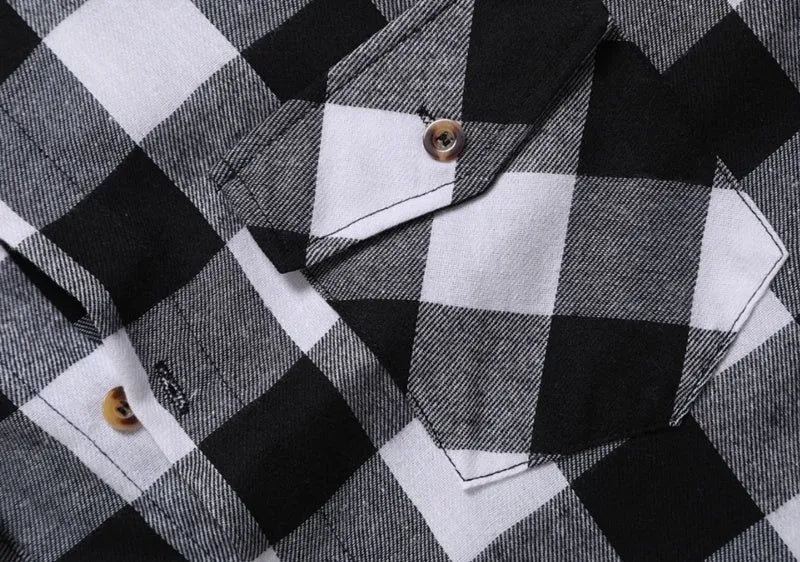 Men's long-sleeved black and white checked shirt with lapel collar and double chest pockets, front view.