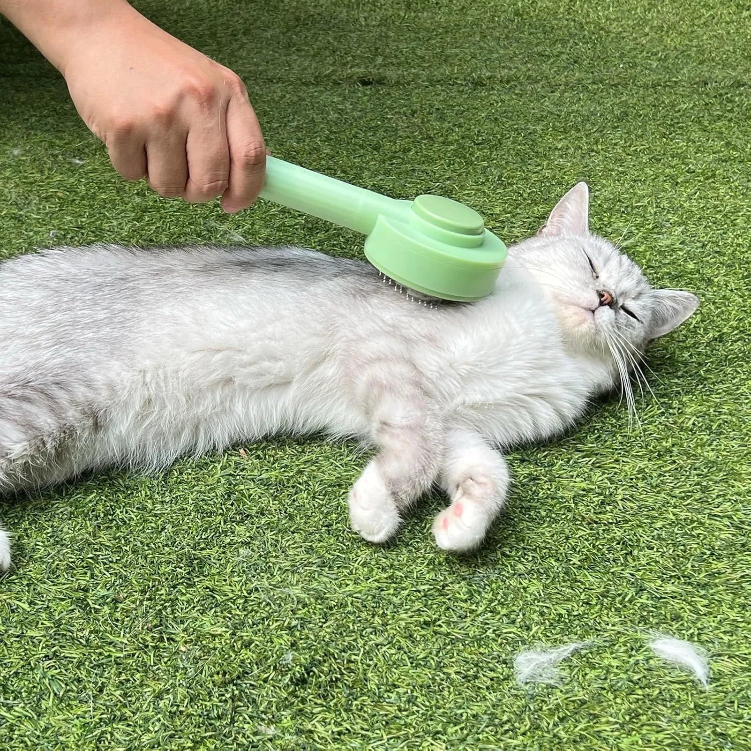 Green and yellow 2-in-1 pet grooming brush with stainless steel teeth and hanging hook