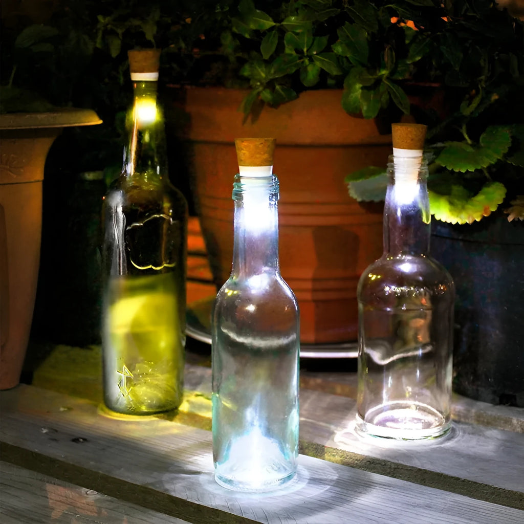 White plastic LED rechargeable bottle cap cork light with 15 beads, shown next to a wine bottle for scale.