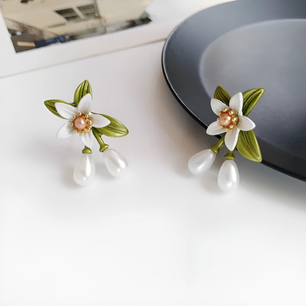 Women's alloy flower earrings showing camellia stud and ear clip options with personality contrast colour