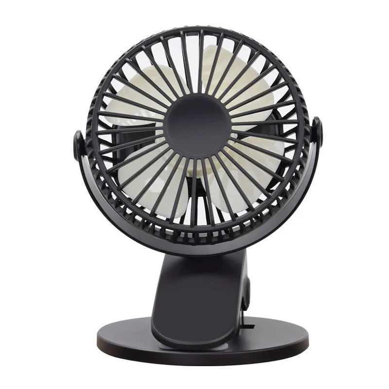 Small white USB clip fan with plastic blades attached to a desk edge, showing piano button switch and brushless motor.