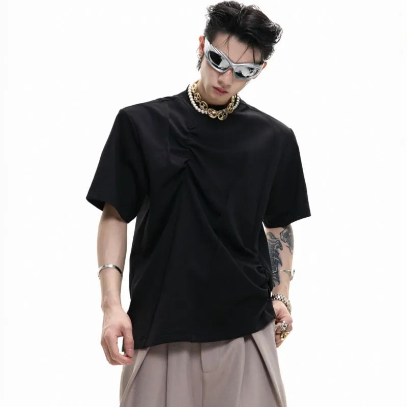 Men's grey pleated cotton t-shirt with round neck and short sleeves on a loose fit model